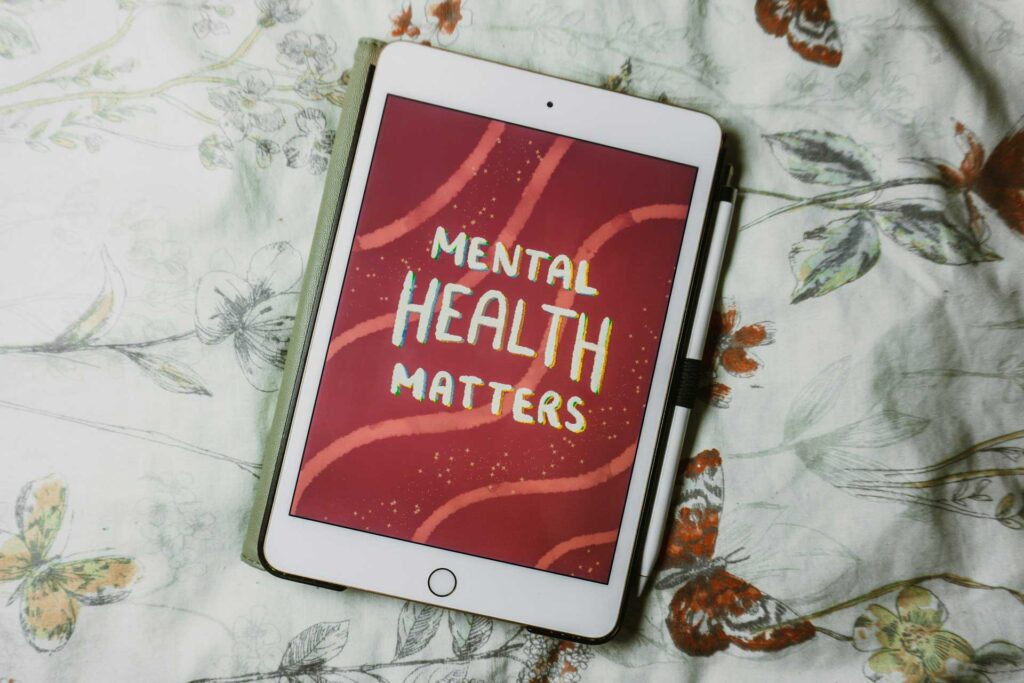 A tablet displaying "Mental Health Matters" on its screen, emphasizing the importance of recognizing signs of mental illness