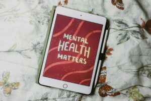A tablet displaying "Mental Health Matters" on its screen, emphasizing the importance of recognizing signs of mental illness